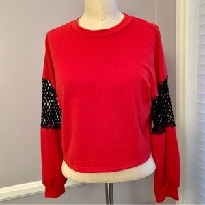 Red cropped crew neck top long sleeves with black mesh insets